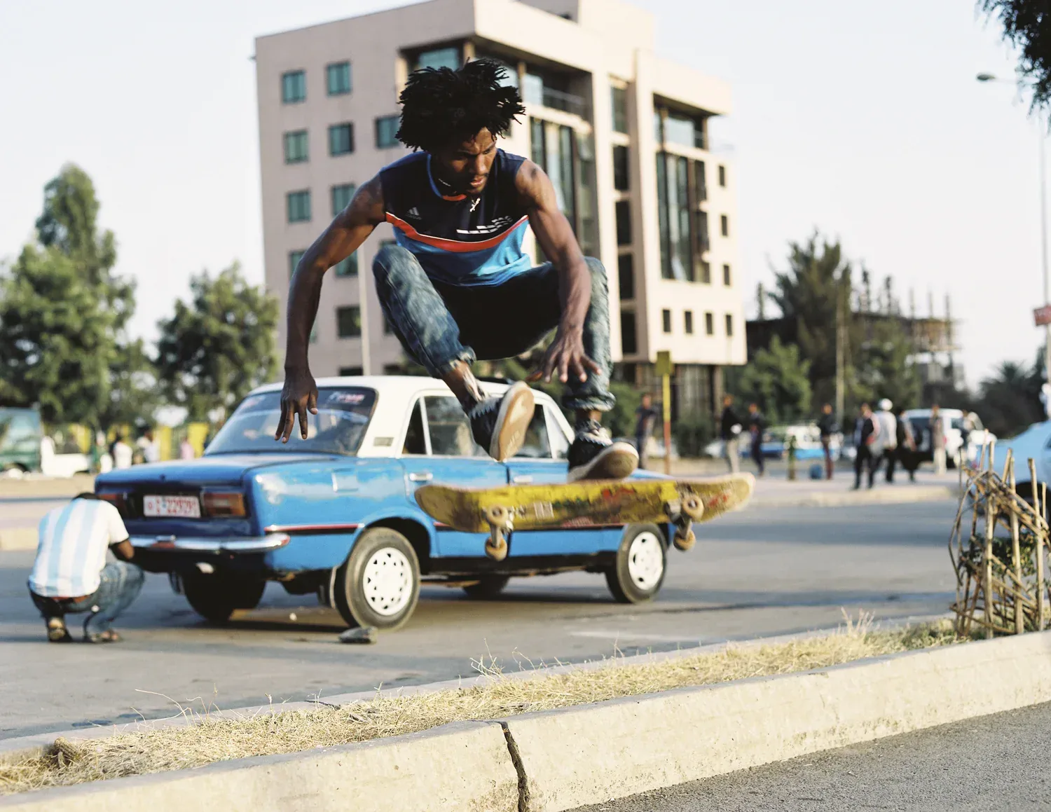 Skateboarder jumping over a car in Addis Ababa